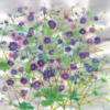 Greeting card with delicate purple wildflowers and green stems on a soft, shimmering background