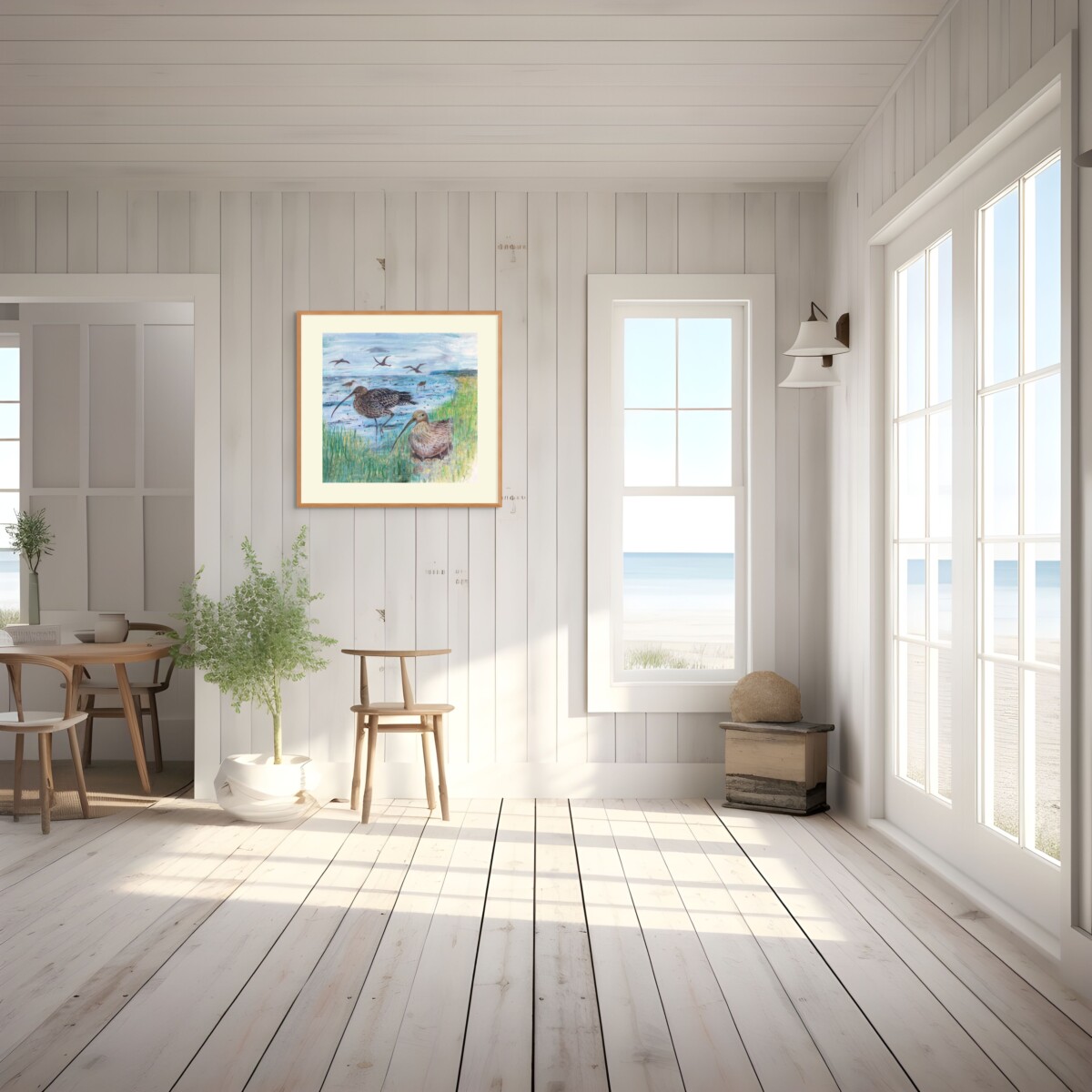 A picture of a beach house with a painting hanging on the wooden wall of Curlews beside the water.